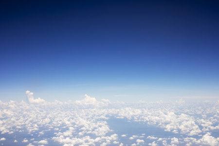 Blue sky background and white clouds soft focus, top view take a picture on airplaneの写真素材