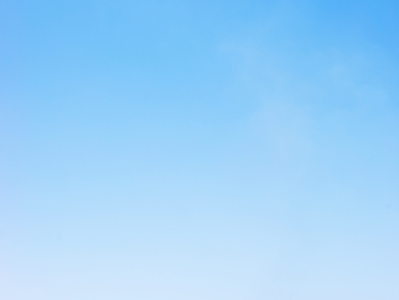 Blue sky background and white clouds soft focus, and copy space.の写真素材