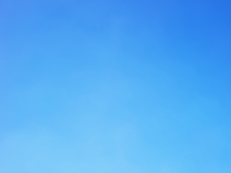 Blue sky background and white clouds soft focus, and copy space.の写真素材