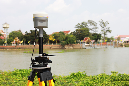 GPS surveying in field river background, Global Positioning System.の写真素材