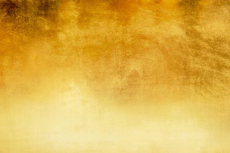 Shiny yellow leaf gold foil texture backgroundの写真素材
