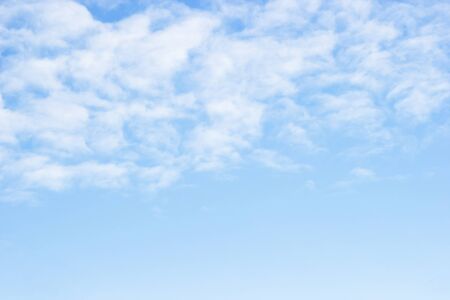 Blue sky background and white clouds soft focus, and copy space.の写真素材