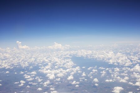 Blue sky background and white clouds soft focus, top view take a picture on airplaneの写真素材