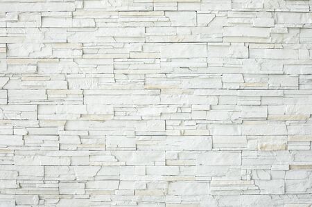 White stone slate wall as a background or textureの写真素材