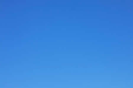Clear blue sky background and empty space for your design, no cloud horizontal shape.の写真素材