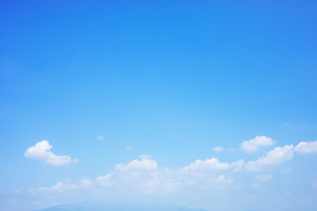 Blue sky background and white clouds soft focus and mountain, copy space horizontal shape.の写真素材