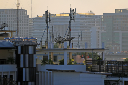 top view of urban with parabolic satellite dishes on rooftopsの写真素材
