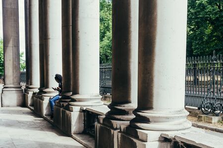 London, UK - July 23, 2018: colonnade of the Royal Naval College, the former training site of Officers in the British Royal Navy until 1998 which is now open to the publicのeditorial素材