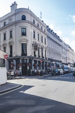 London/UK- 22/07/19: people sitting at the tables just outside the Mitre Pub on Craven Terrace in Bayswater. Pubs are a social drinking establishment and a prominent part of British cultureのeditorial素材
