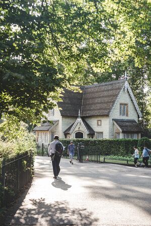 London/UK - 22/07/19: people walking past the Buckhill Lodge, Victorian style detached cottage in Kensington Gardens. It was completed in 1852のeditorial素材