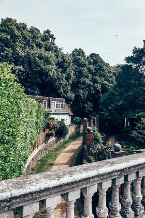 London/UK - 17/07/2019: House, fence, road and a pergola in The Hill Garden, part of the Hampstead...
