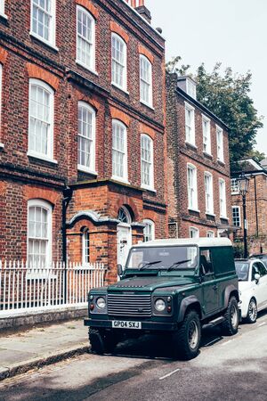 London/UK - 17/07/2019: dark green Land Rover Defender parked on a side of the road in London. British four-wheel drive off-road vehicle developed in the 1980s from the original Land Rover seriesのeditorial素材