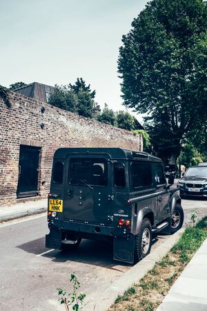 London/UK - 17/07/2019: Land Rover Defender parked on a side of the road in London. British four-wheel drive off-road vehicle developed in the 1980s from the original Land Rover seriesのeditorial素材