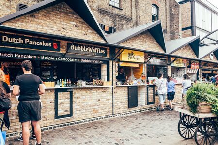 London/UK - July 17, 2019: People buying food in a stalls at Stables Market, located in the historic former Pickfords stables and horse hospital in Camden Townのeditorial素材