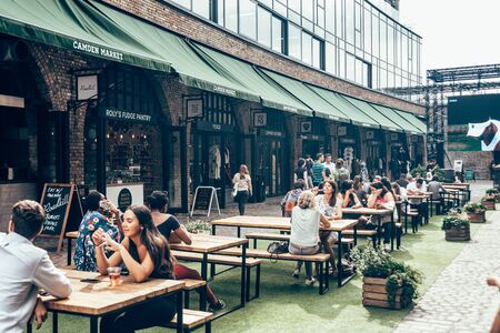 London/UK - July 17, 2019: People eating their food at Stables Market sitting area, located in the historic former Pickfords stables and horse hospital in Camden Townのeditorial素材