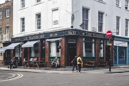 London/UK - 17/07/2019: people sitting at the tables just outside the Trader's Inn pub on Church Street in Marylebone. Pubs are a social drinking establishment and a prominent part of British cultureのeditorial素材