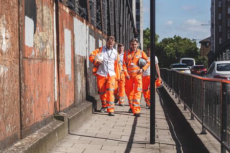 London/UK-22/07/19: Crossrail construction workers walking along the street. Crossrail Limited is...