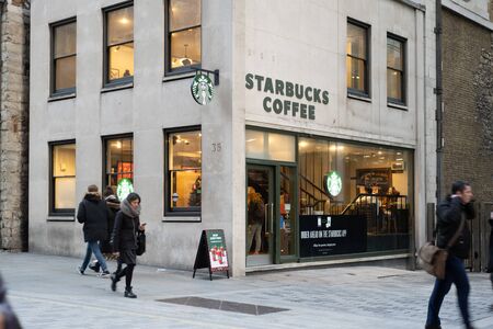London / UK - Nov 29, 2019: people walking past the Sturbucks cafe on the Walbrook Street in Londonのeditorial素材