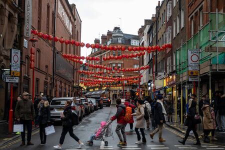 London / UK - Dec 01, 2019: people crossing Little Newport Street in Chinatown. It contains a number of Chinese restaurants, bakeries, supermarkets, souvenir shops, and other Chinese-run businessesのeditorial素材