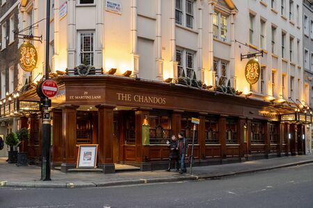 London / UK - Dec 01, 2019:  people walking past The Chandos Pub on the crossroad of William IV...