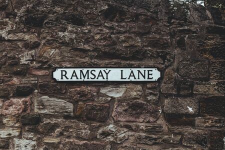 Ramsey Lane name sign on a stone wall, Old Town of Edinburgh, Scotlandの写真素材
