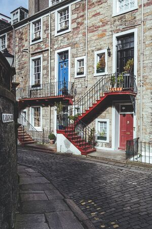 Colorful entrance doors on a facade of a traditional stone house in Ramsey Gardens, Old Town of the Edinburgh city, Scotlandの写真素材