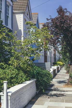 Pastel-colored terraced houses on White Hart Lane in Barnes. Terrace house is a form of medium-density housing that originated in Europe, whereby a row of attached dwellings share sidewallsの写真素材