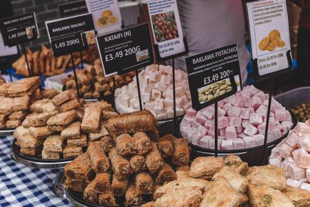 Middle-East pastries, like baklava, on sale in a stall on a street market in Londonの写真素材