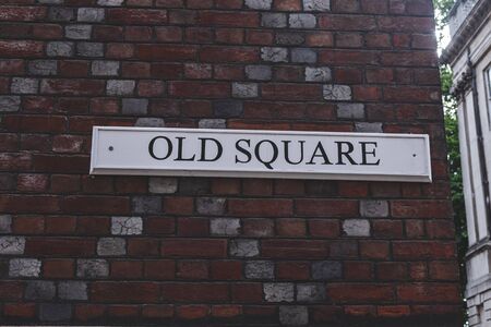 Old Square name sign on a brick wall, Holborn, London