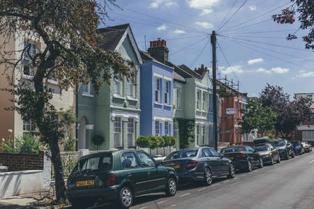 London/UK-1/08/18: pastel-colored terraced houses on White Hart Lane in Barnes. Terrace house is a...
