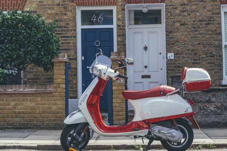 London/UK-1/08/18: red-white Vespa scooter, that has been known for their painted pressed steel...