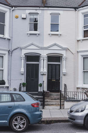 London/UK - 30/07/18: Black and grey entrance doors on a facade of traditional English terraced...