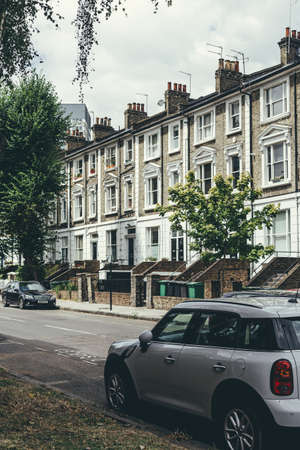 London/UK-30/07/18: a row of typical British Georgian terrace houses. Terrace house is a form of medium-density housing that originated in Europe, whereby a row of attached dwellings share side wallsのeditorial素材