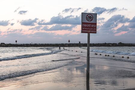 "Swimming prohibited" warning sign at the designated area on the Tel Aviv city beach in Israelの写真素材