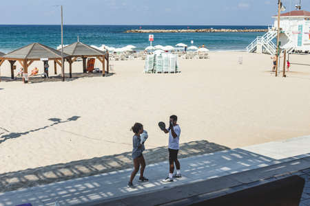 Tel Aviv/Israel-10/10/18: a woman boxing with her trainer on a beach in Tel Aviv. Healthy lifestyle conceptのeditorial素材