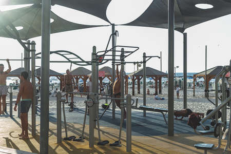 Tel Aviv/Israel-10/10/18: men training in an outdoor gym on the beach. The outdoor gym is a gym...