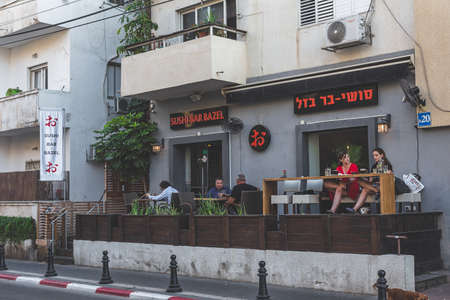 Tel Aviv/Israel-12/10/18: people in the Sushi Bar Bazel outdoor dining terrace on Ben Yehuda Streetのeditorial素材