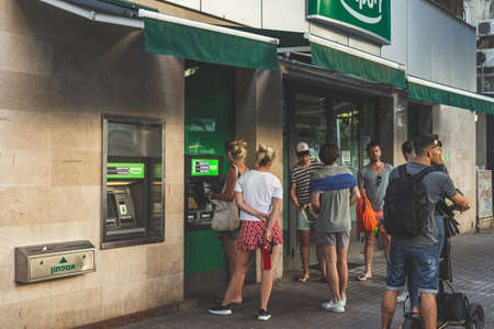 Tel Aviv/Israel-12/10/18: people in a line waiting to withdraw cash in an ATM of a local bank on Dizengoff Street in Tel Avivのeditorial素材