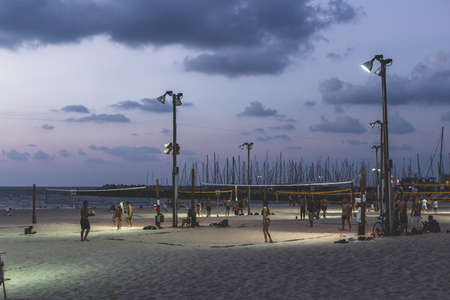 Tel Aviv/Israel-12/10/18: people playing on the public beach volleyball courts in Tel Aviv on a warm...