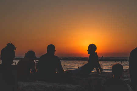 Tel Aviv/Israel-13/10/18: People seeing off the sunset over the Mediterranean Sea on the seacoast in...