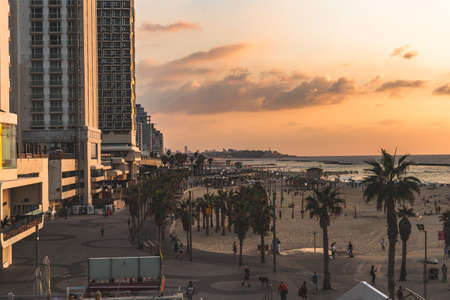 Tel Aviv/Israel-8/10/18: tourists walking on Lahat Promenade and Gordon Beach in golden hours on the sunset. Tel Aviv Promenade runs along the Mediterranean seashore in Tel Aviv, Israelのeditorial素材