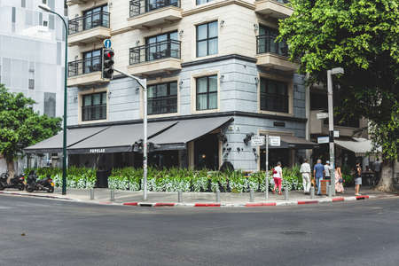 Tel Aviv/Israel-9/10/18: people walking past Cafe Popular located in the Jacob Samuel boutique hotel, at the intersection of Dizengoff-Arlozorov streets in Tel Aviv, Israelのeditorial素材