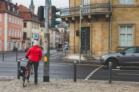 Wurzburg/Germany-3/1/19: Cyclist waiting for a traffic light on a street in Wurzburg. Cycling in...