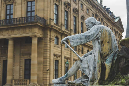 Wurzburg/Germany-3/1/19: the metal sculpture of a writer sitting at the base of the Franconia Fountain on Residence Square in the town of Wurzburgのeditorial素材