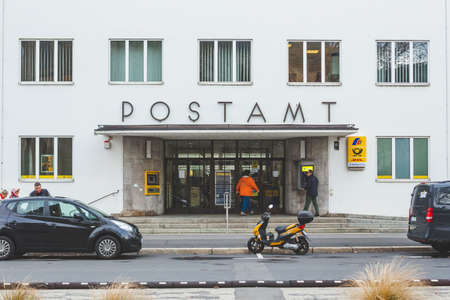 Bad Kissingen/Germany-31/12/18: people walk in and out of the Deutsche Post Office on MÃ¼nchner Street. Deutsche Post AG is a German multinational package delivery and supply chain management companyのeditorial素材