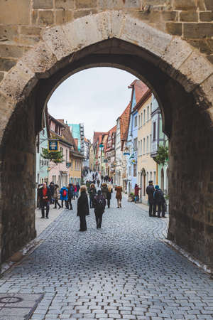 Rothenburg/Germany-1/1/19: the view of the old town of Rothenburg ob der Tauber through the arch in a wall. The town is a well known destination for tourists from around the worldのeditorial素材