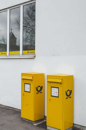 Bad Kissingen/Germany-31/12/18: two yellow Deutsche post mail boxes, installed on a street. Deutsche Post AG is a German multinational package delivery and supply chain management companyのeditorial素材