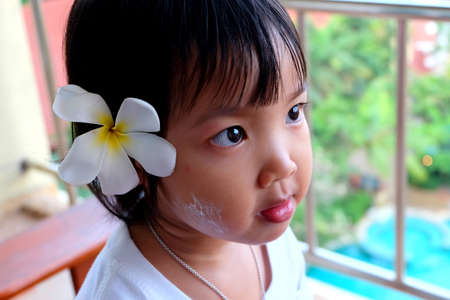 Cute Asian girl  looks at the camera and smiling.の写真素材
