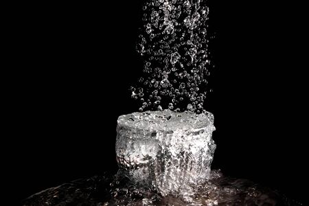The rapid flow of water into the bowlの写真素材