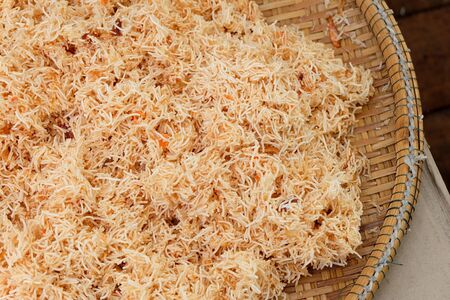 Sweet  Sour Crispy Noodles in wicker basket of home grown food Thailand.